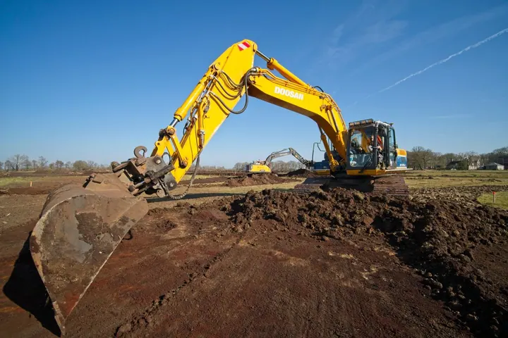 Yellow excavator working on an earthmoving site