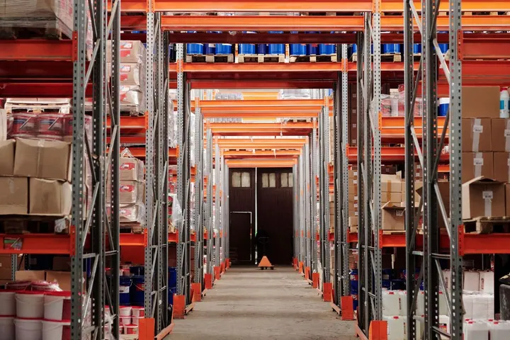 Shelves of goods in a warehouse aisle